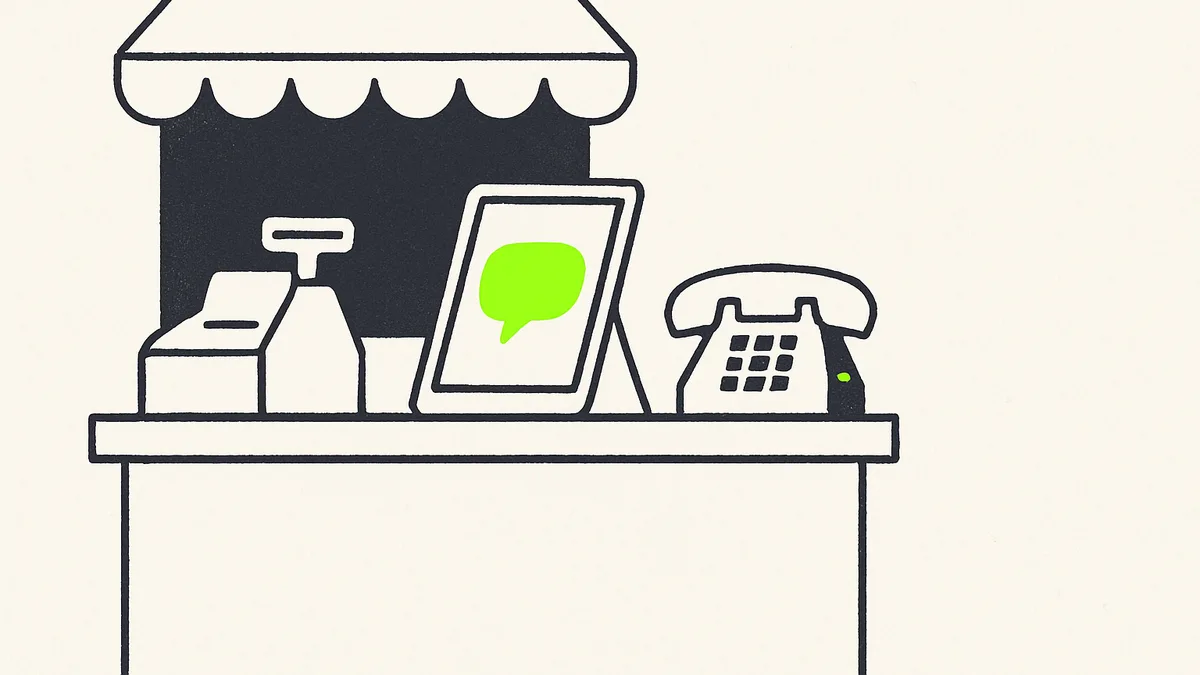 A small shop counter with a tablet showing a chat window and a small speech bubble icon labeled as automated, next to an old-fashioned phone.