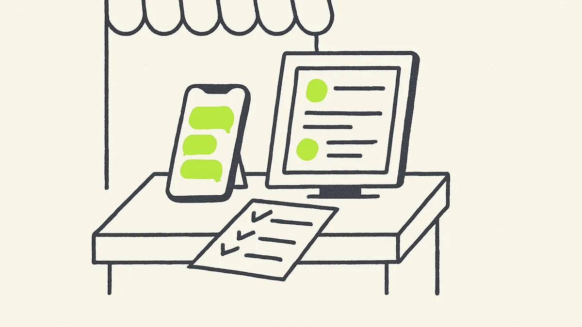 A shop owner's phone shows a chat app next to a scrolling social media feed on a second screen, with a small paper checklist propped against the till.